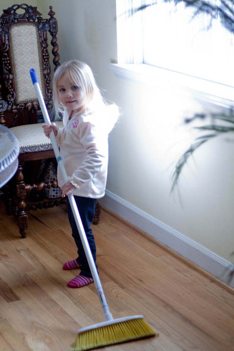 Young daughter sweeping