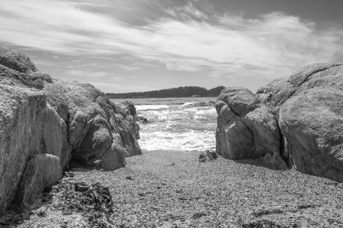 water washes up between two rocks at Carmel River State Beach