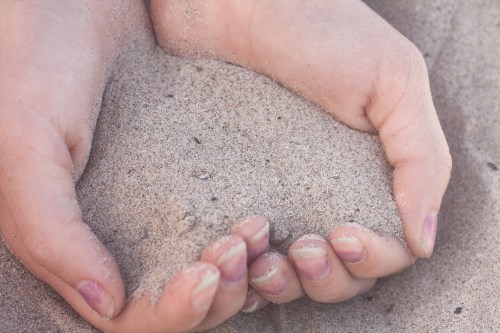 California beach sand cupped in hands Not So SAHM