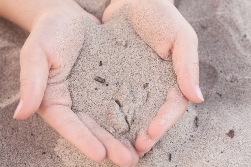 California beach sand cupped in hands Not So SAHM