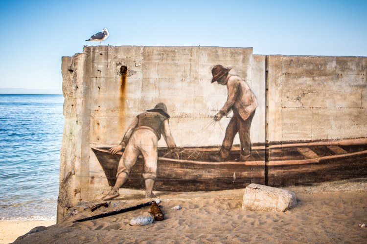 A mural of two fishermen prepping their boat is painted on the sea wall in Monterey Bay NotSoSAHM