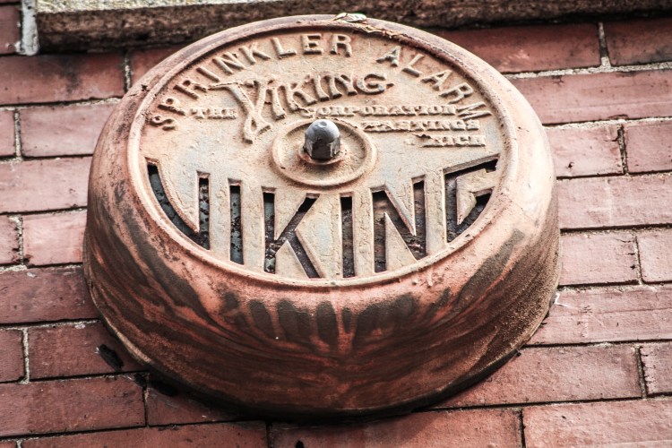 an old Viking Sprinkler Alarm is still attached to the side of a building in downtown Macon, GA NotSoSAHM