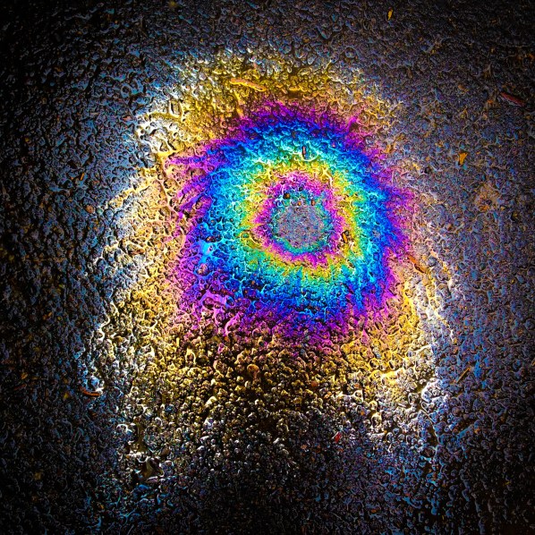 An oil spill on the ground has a rainbow of colors NotSoSAHM