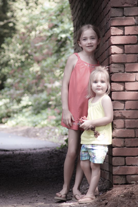 Two girls stand next to a brick wall on the grounds of the Biltmore Estate, Asheville, NC Not So SAHM