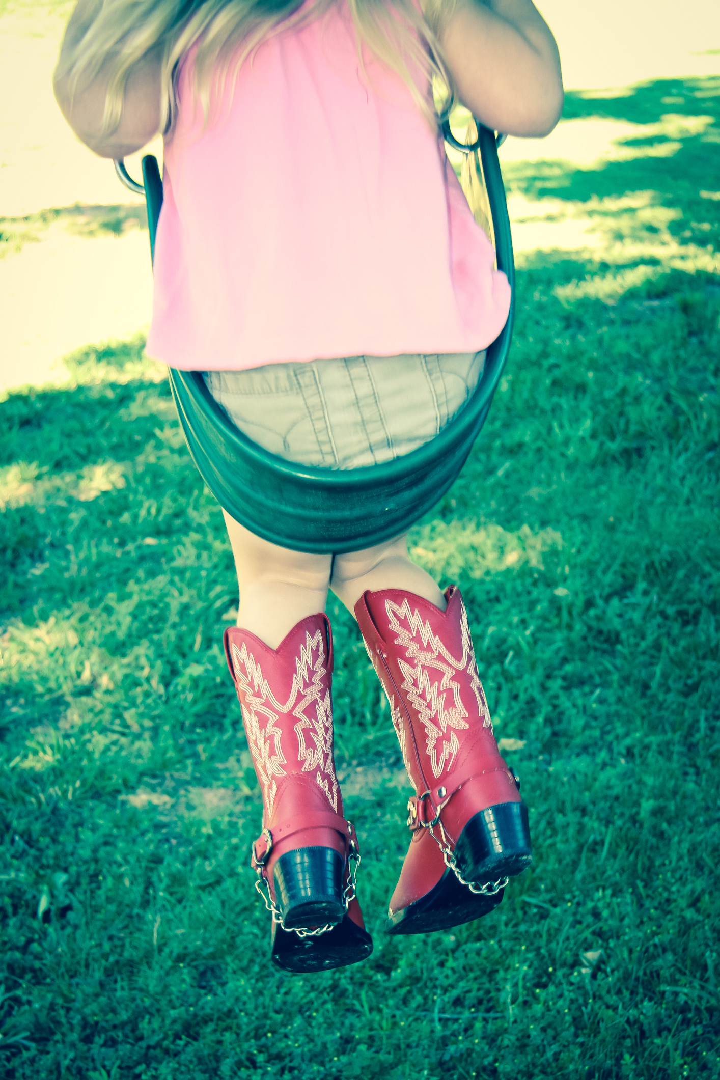 Girl on swing with red cowboy boots Not So SAHM