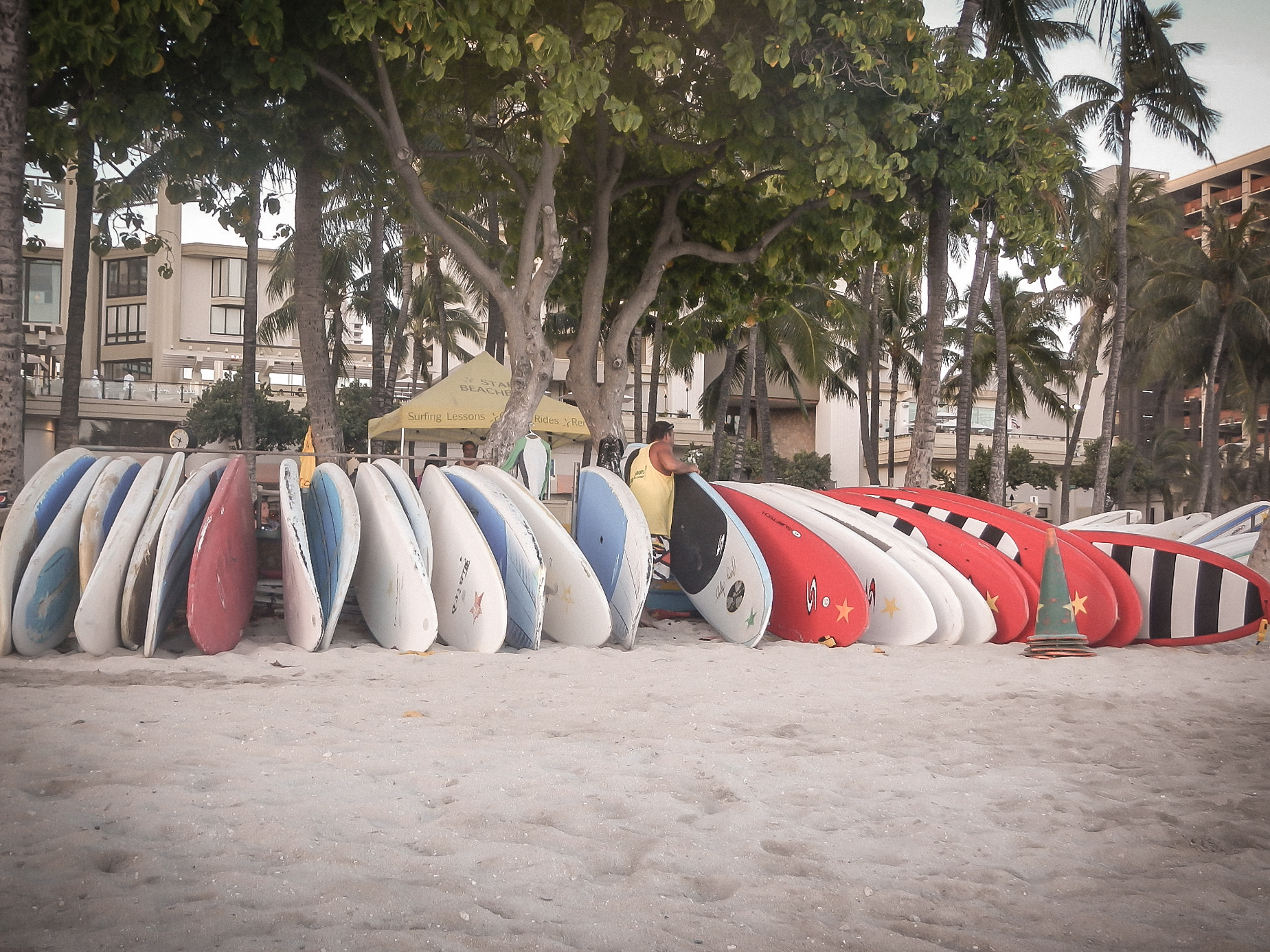 A man sets up surf boards for rent on Waikiki Beach on Oahu, Hawaii Not So SAHM