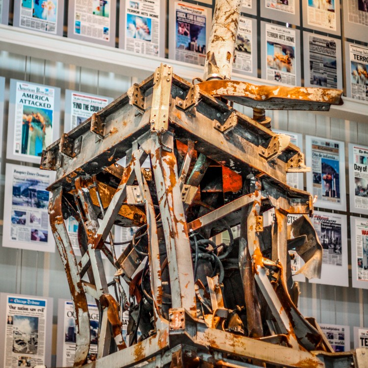 A piece of the steel structure of the World Trade Center is on display at the Newseum in front of various front pages of papers that detail the terrorism of 11 September 2001. Not So SAHM