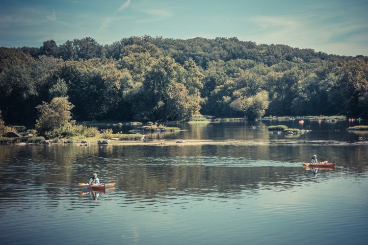 People float down the Potomac River in kayaks. Not So SAHM