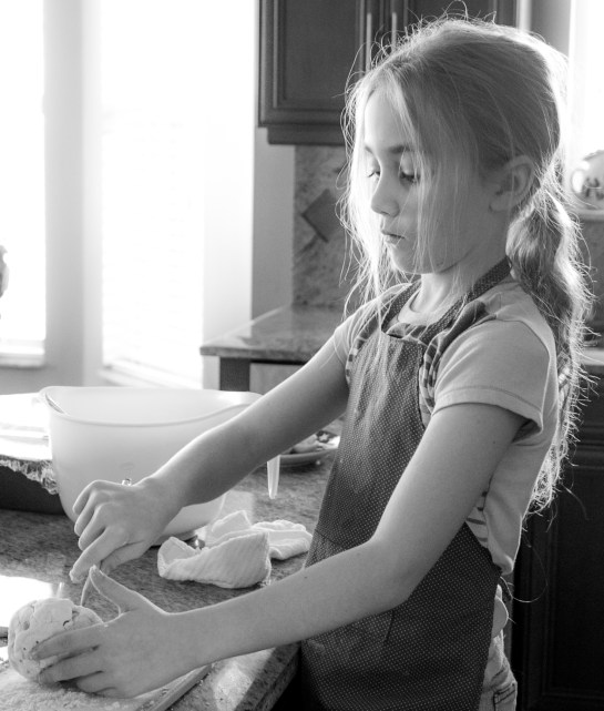 Girl works with salt dough in the kitchen. Not So SAHM