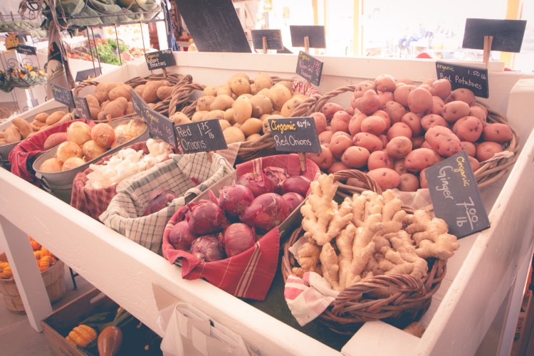 Fresh veggies sit in individual baskets at a Salinas, CA farm stand. Not So SAHM
