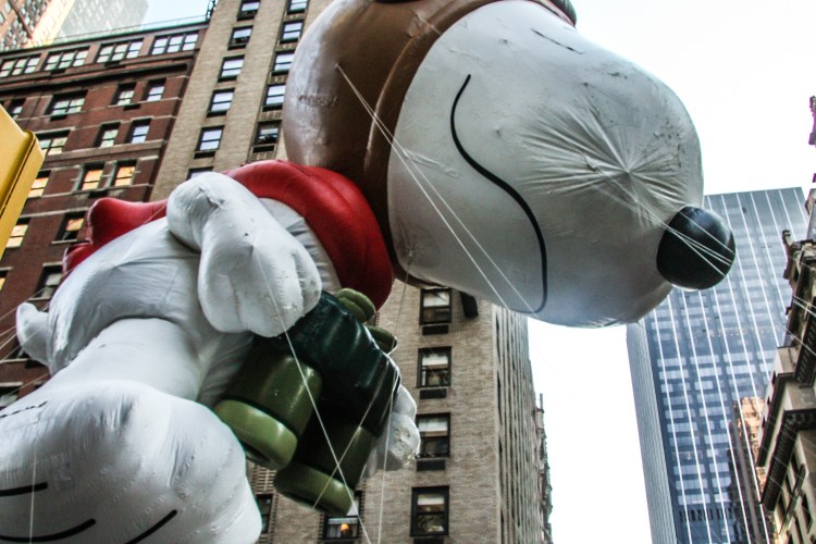 The snoopy balloon looms overhead on a new york street during the macy's thanksgiving day parade. Not So SAHM