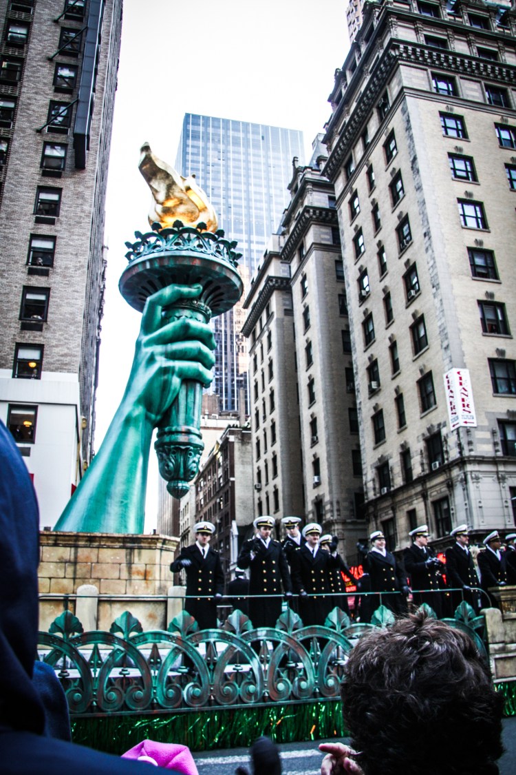 A parade float with the torch of the statue of liberty floats by in the macy's thanksgiving day parade. Not So SAHM