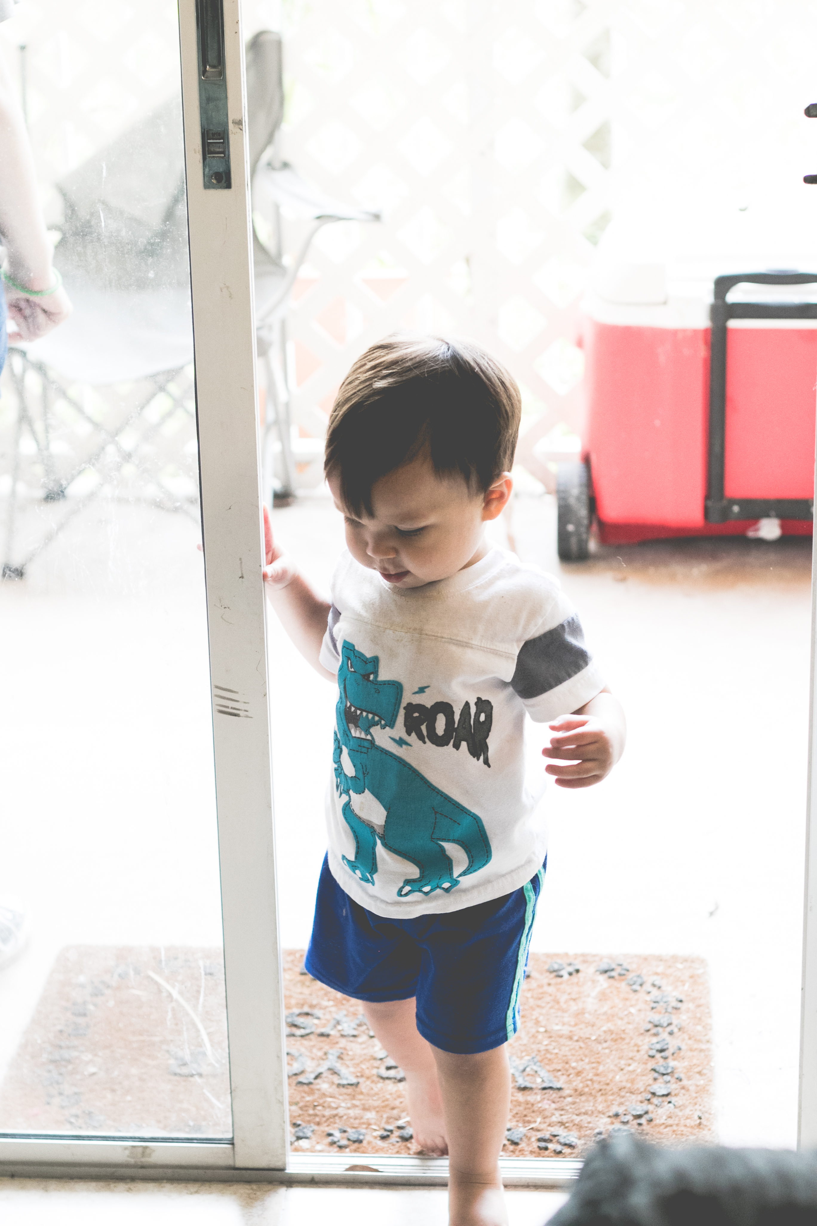 A boy comes in from playing outside. Photo by VSD Photography